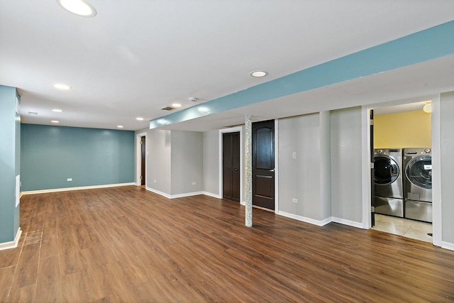 basement with washing machine and dryer and hardwood / wood-style flooring