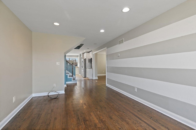 unfurnished room with dark hardwood / wood-style floors