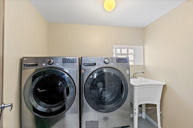 laundry area with washer and dryer and sink