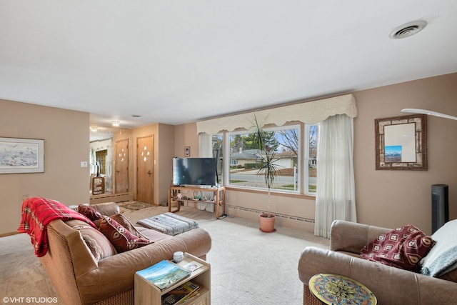 carpeted living room with a baseboard heating unit