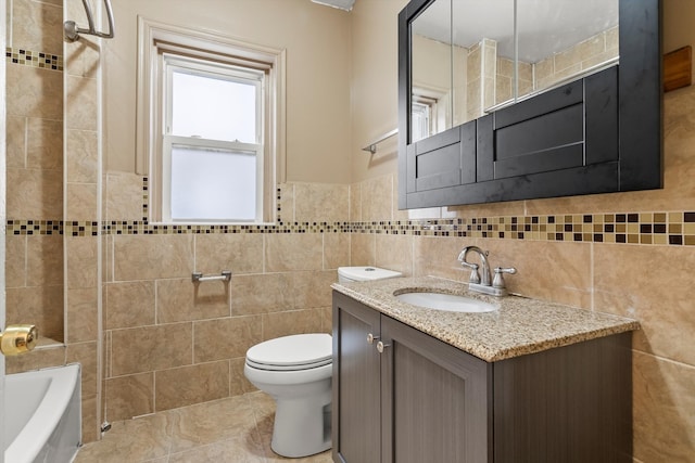 full bathroom with vanity, toilet, washtub / shower combination, and tile walls