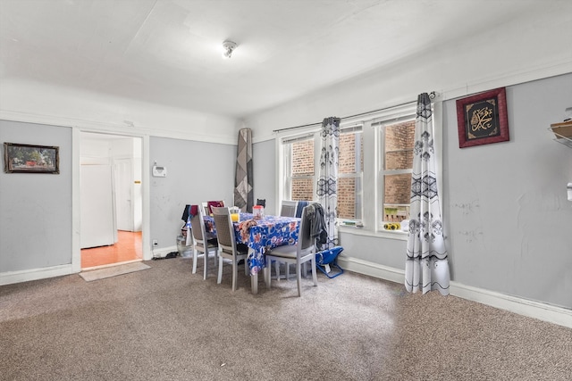 dining space with carpet flooring