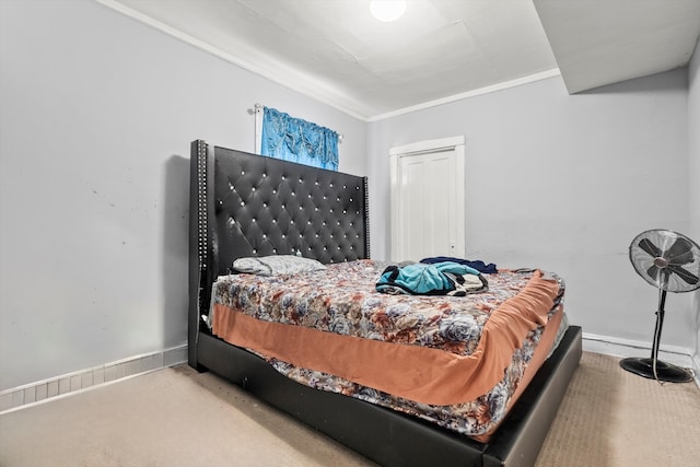 bedroom featuring crown molding and carpet