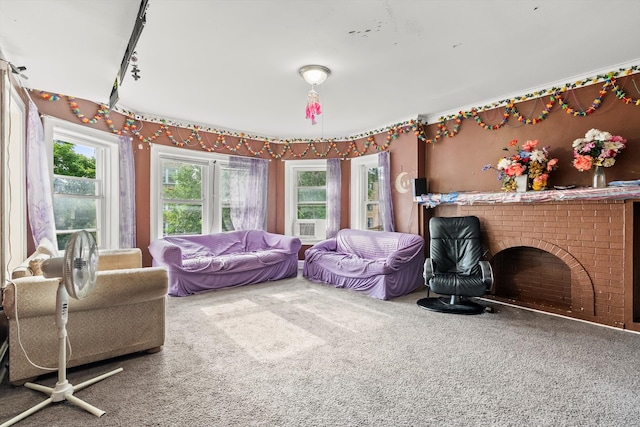 carpeted living room with plenty of natural light and a fireplace