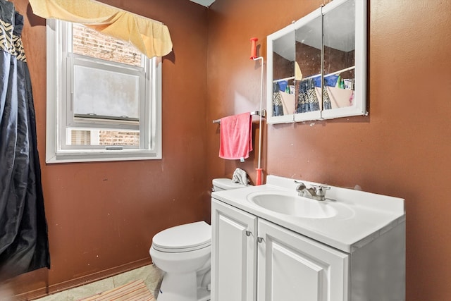 bathroom featuring tile patterned flooring, vanity, and toilet