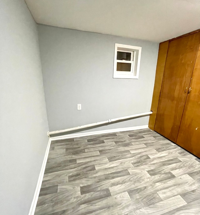 unfurnished bedroom featuring light hardwood / wood-style flooring and a closet