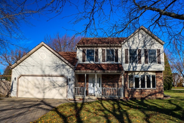 view of front facade featuring a garage, a front yard, and covered porch