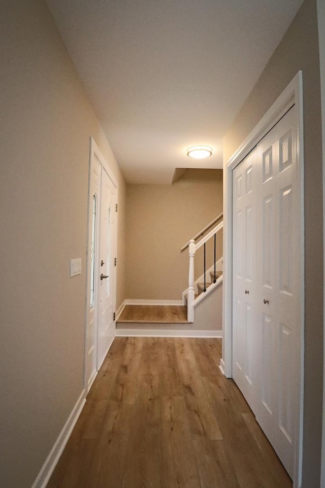 corridor with wood-type flooring