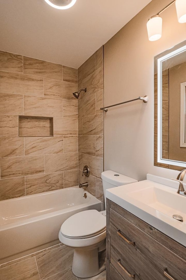 full bathroom with tiled shower / bath, vanity, toilet, and tile patterned flooring