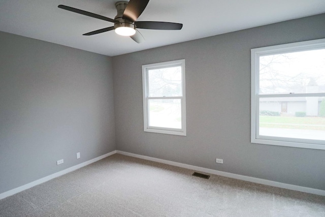 spare room featuring carpet flooring and ceiling fan