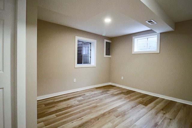 basement with light hardwood / wood-style floors