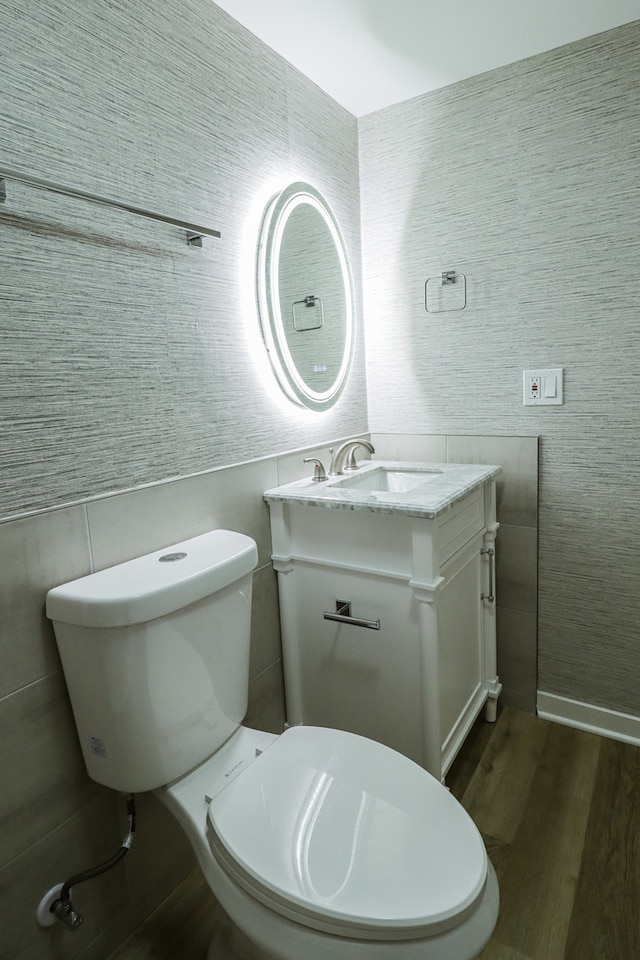 bathroom featuring vanity, hardwood / wood-style flooring, and toilet