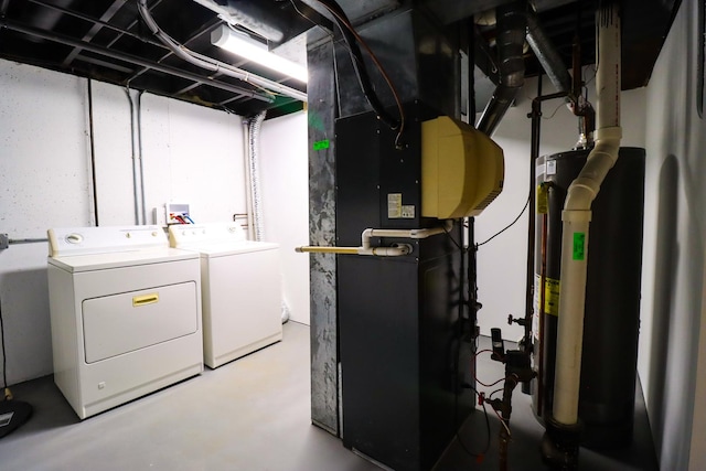 washroom featuring water heater and washer and clothes dryer