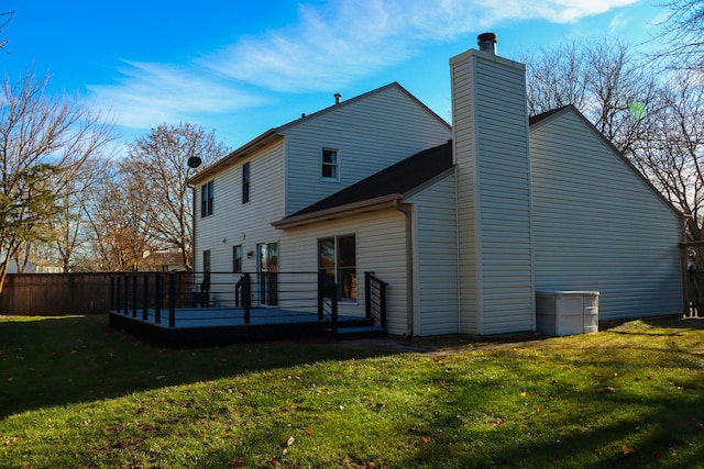 back of house with a wooden deck and a yard