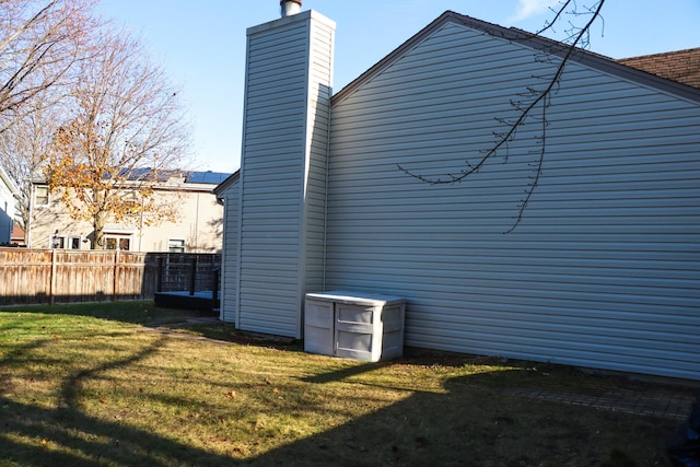 view of property exterior with a yard