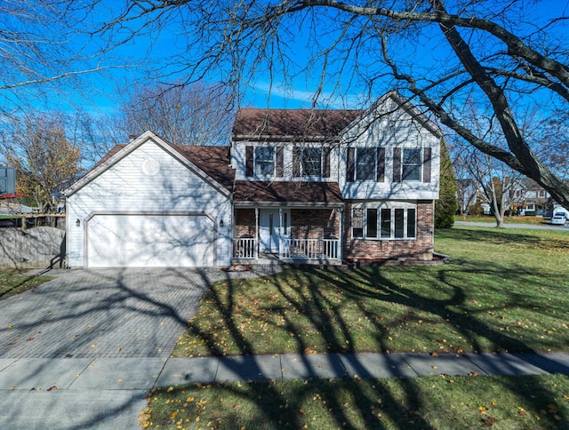 view of front of property with a garage, covered porch, and a front yard