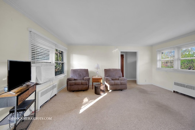 sitting room with plenty of natural light, radiator heating unit, and light carpet