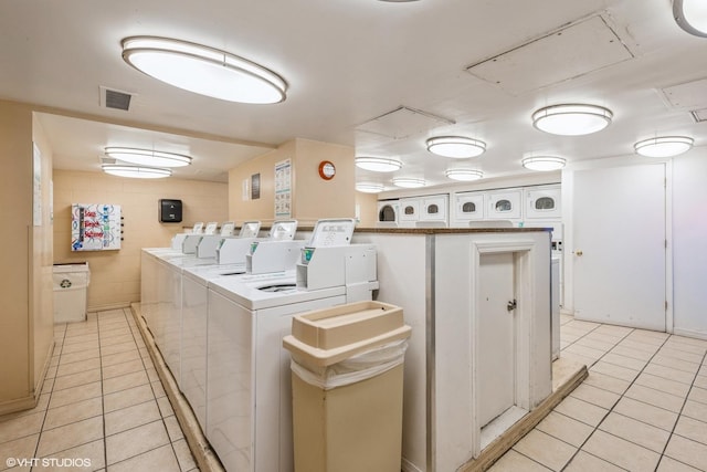 washroom with light tile patterned flooring and independent washer and dryer