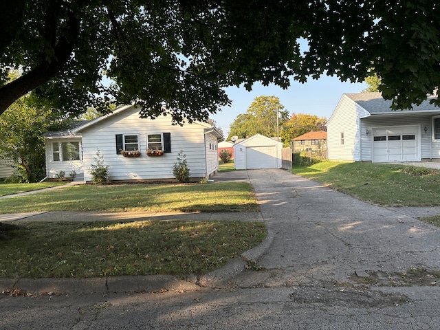 view of front of property with an outbuilding, a front yard, and a garage