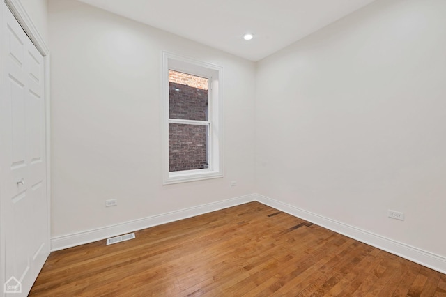 spare room featuring hardwood / wood-style flooring