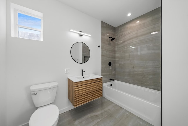 full bathroom with vanity, tiled shower / bath combo, and toilet