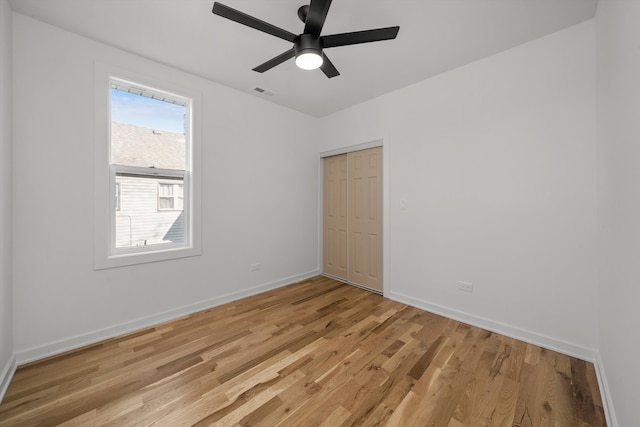 empty room featuring ceiling fan and light hardwood / wood-style floors