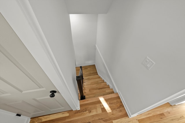 staircase featuring hardwood / wood-style flooring