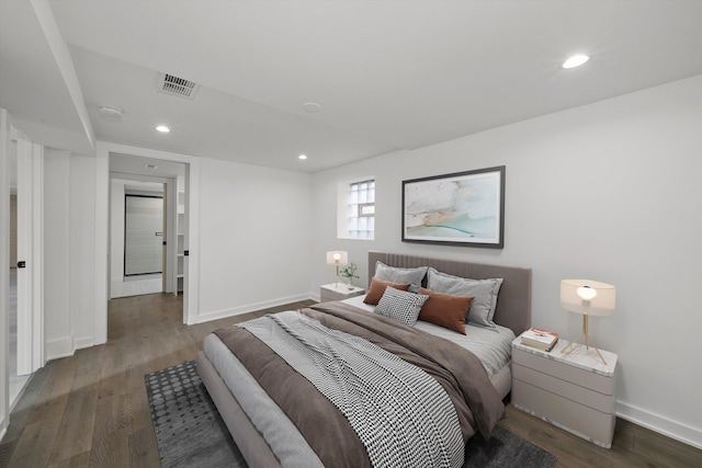 bedroom with dark hardwood / wood-style floors