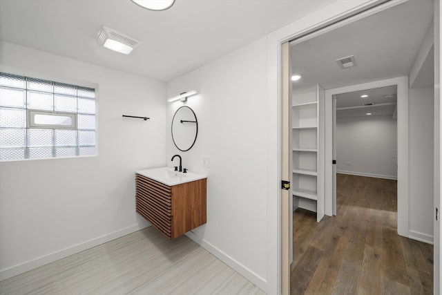 bathroom with hardwood / wood-style flooring and vanity