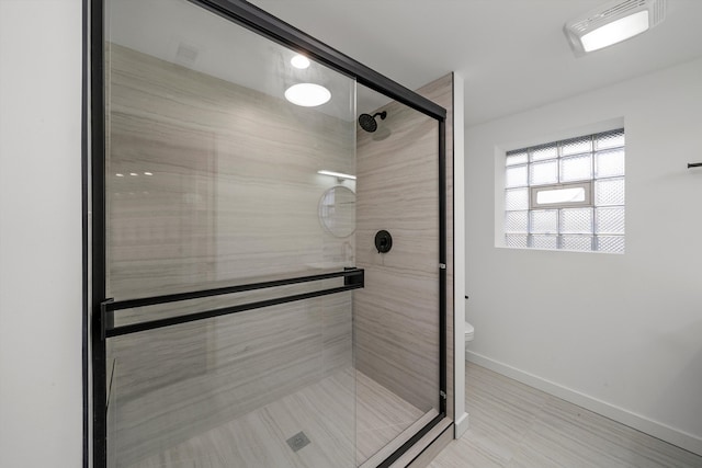 bathroom with toilet and an enclosed shower