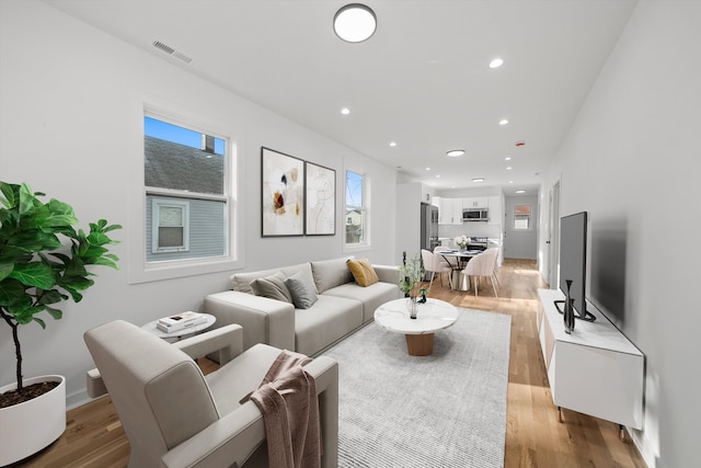 living room with plenty of natural light and light wood-type flooring