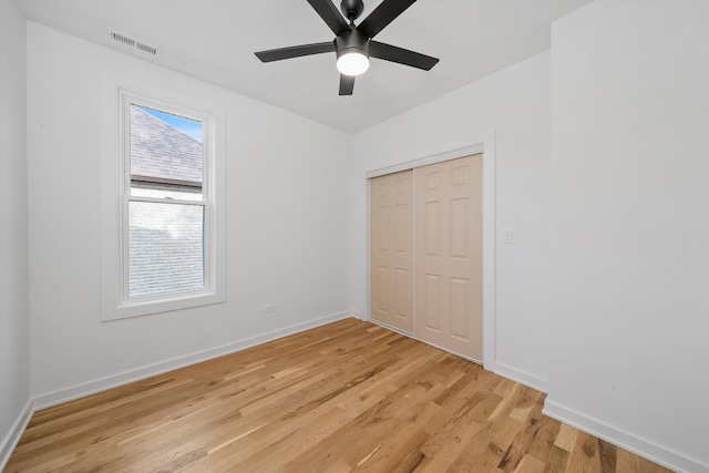 unfurnished bedroom featuring a closet, ceiling fan, and light hardwood / wood-style flooring