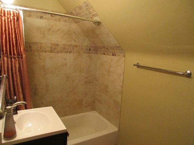 bathroom with vanity, lofted ceiling, and shower / bath combo