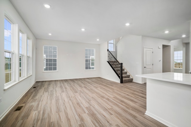 unfurnished living room with light wood-type flooring