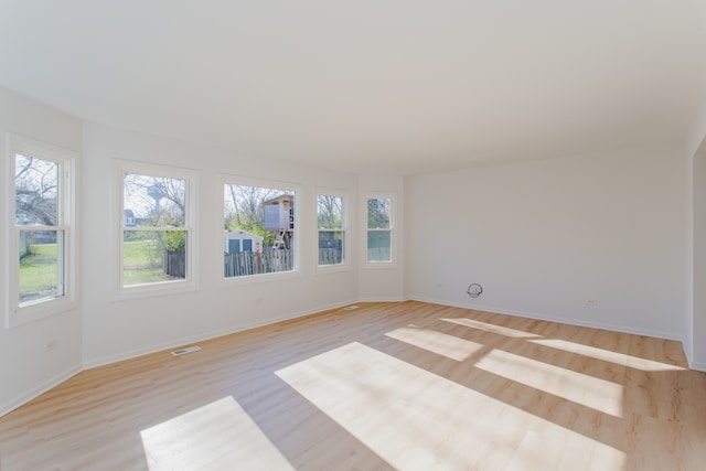 empty room with light hardwood / wood-style flooring