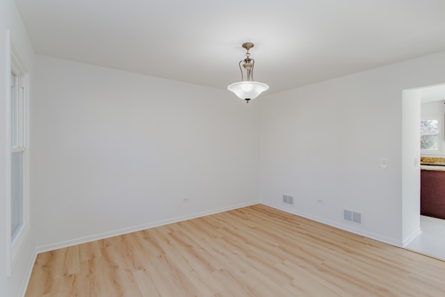 spare room featuring light hardwood / wood-style floors