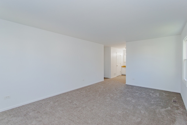 unfurnished room with light carpet