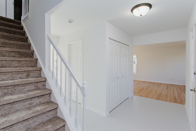 stairs with hardwood / wood-style floors