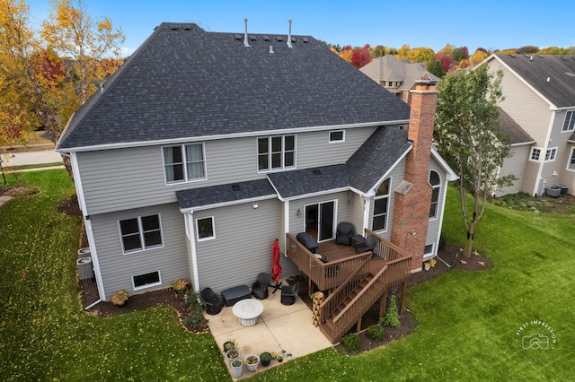 rear view of property featuring a yard, a deck, and a patio area