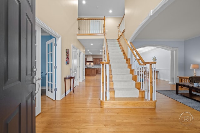 entryway featuring light wood-type flooring and ornamental molding