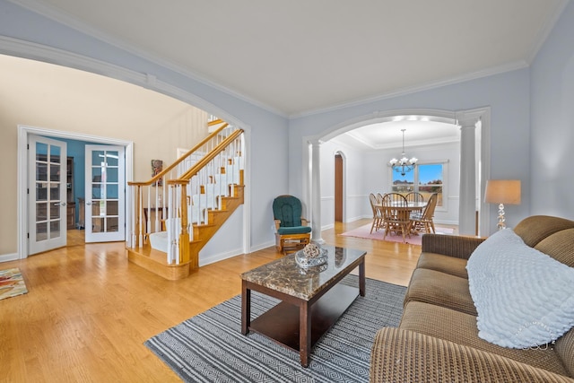 living room with wood-type flooring and ornamental molding