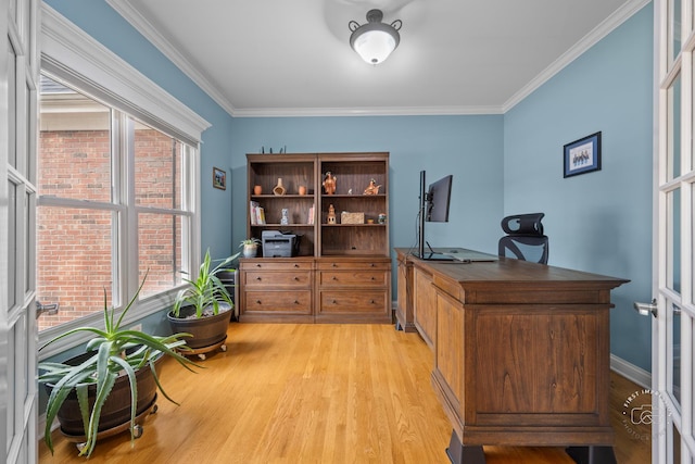 office space with light hardwood / wood-style floors, crown molding, and french doors