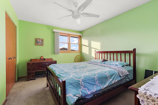 bedroom with a closet, light colored carpet, and ceiling fan