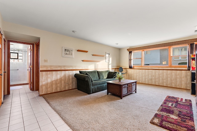 tiled living room featuring wood walls