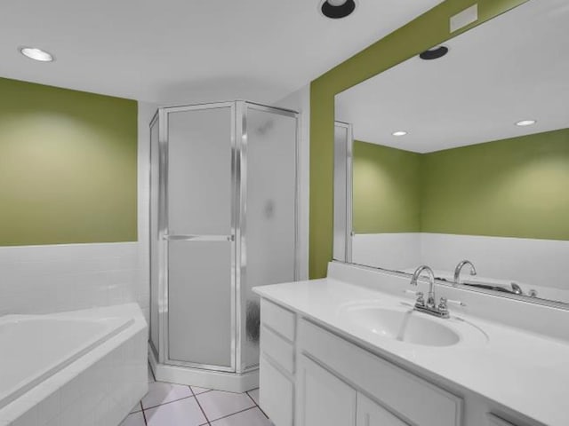 bathroom with tile patterned flooring, vanity, and separate shower and tub