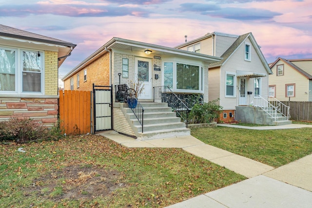 bungalow-style home with a yard