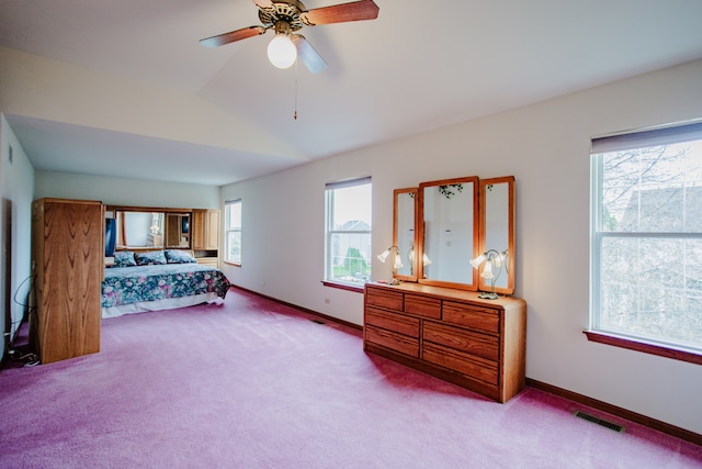 bedroom with light carpet, multiple windows, and ceiling fan