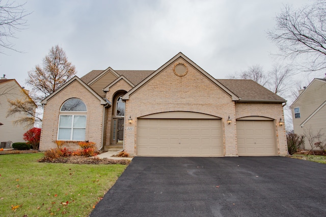 view of front of home featuring a garage and central AC