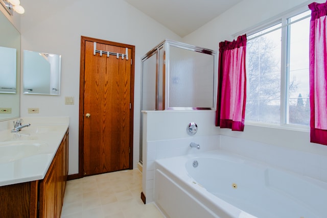 bathroom with vanity, lofted ceiling, and independent shower and bath