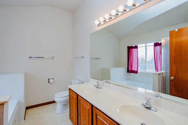 bathroom featuring vanity, a bath, vaulted ceiling, and toilet